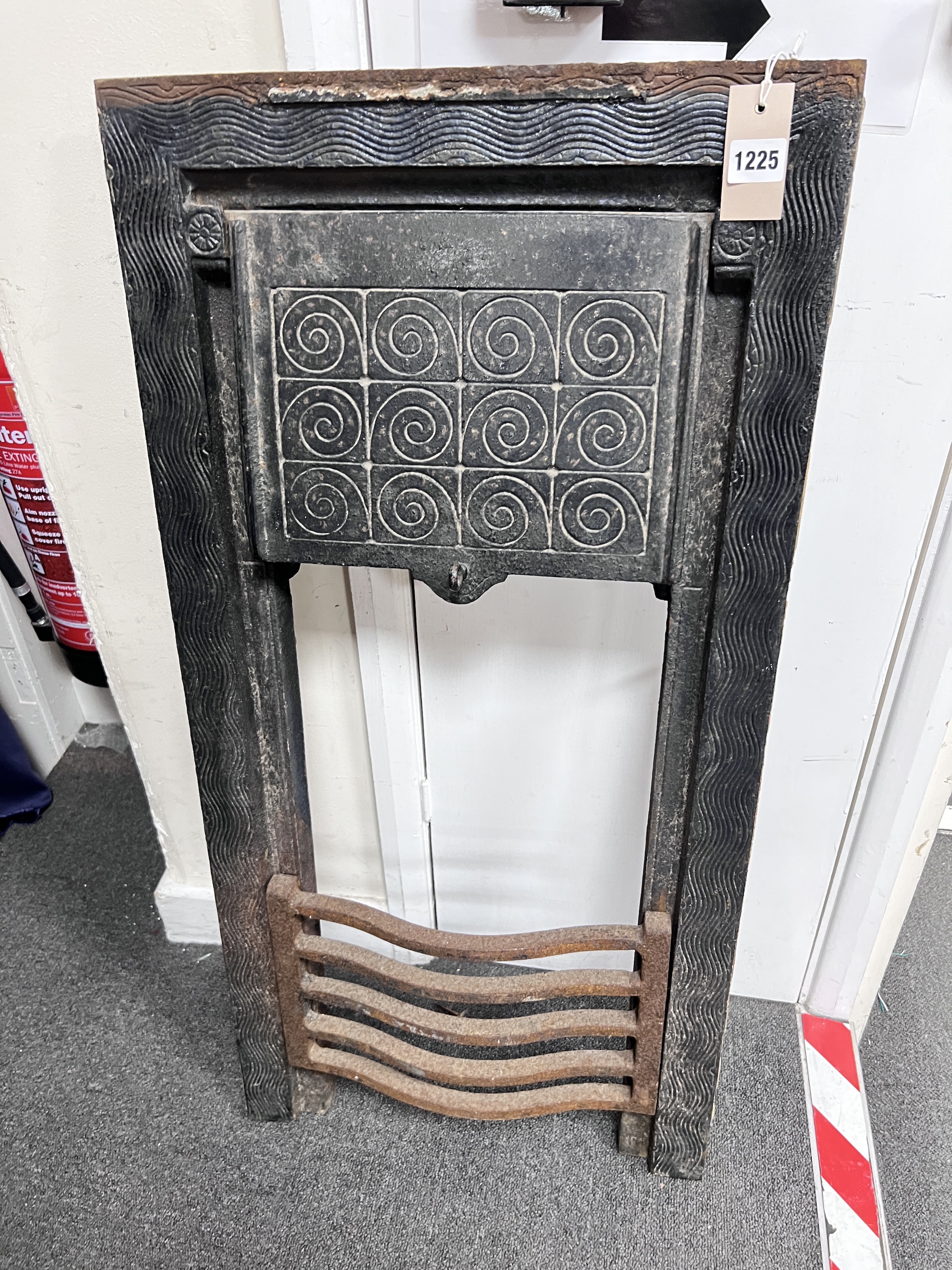 A Victorian cast iron fire insert, height 92cm, width 46cm